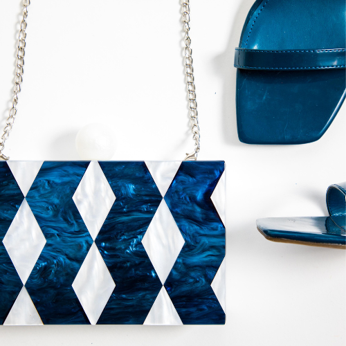 Blue and white acrylic box clutch with chevron pattern and pearl clasp